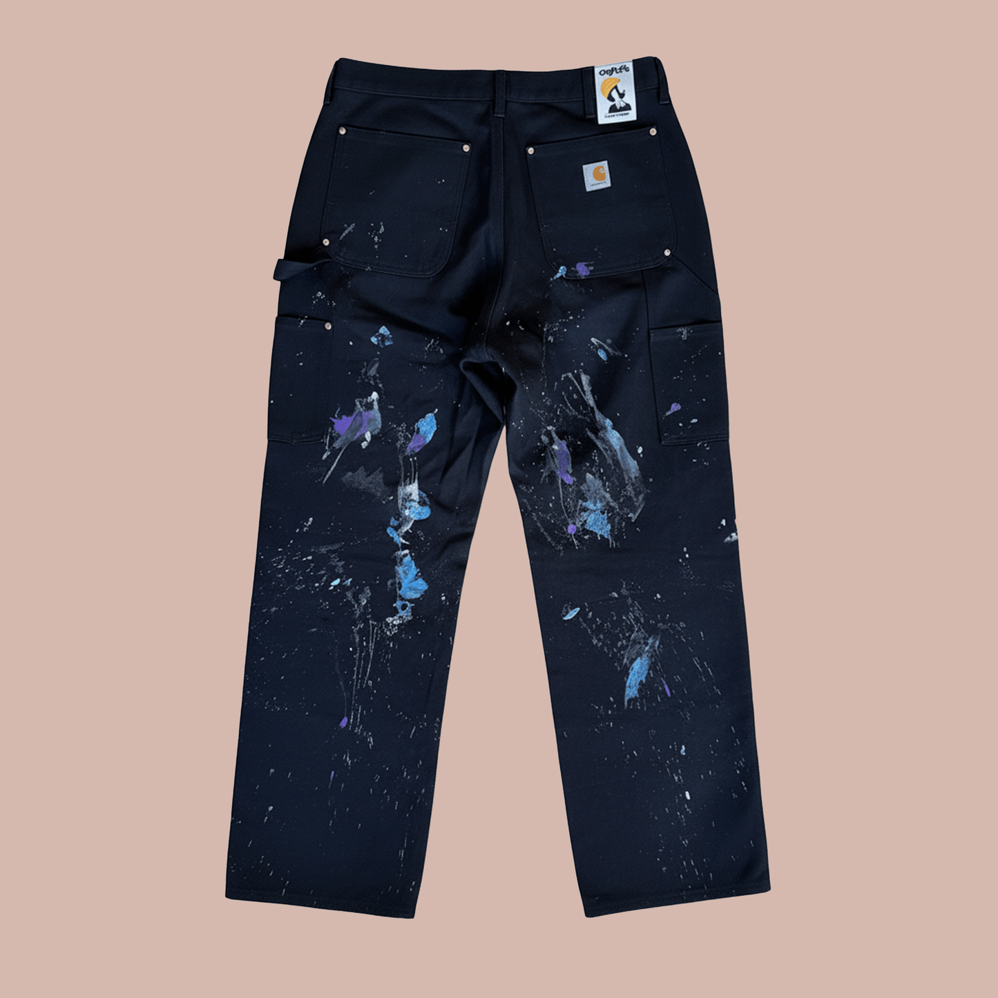 Back view of hand painted work pants featuring colorful splashes by Steven Othello x Carhartt.