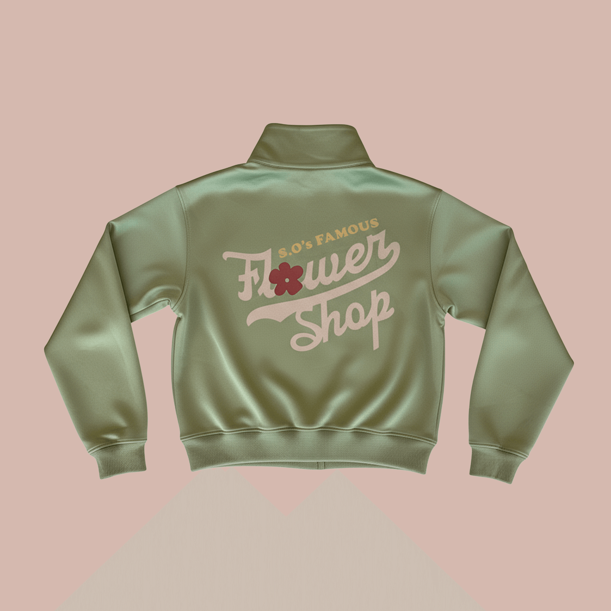 Back view of the Objects Flower Shop track jacket featuring a soft green color and bold vintage graphic design.